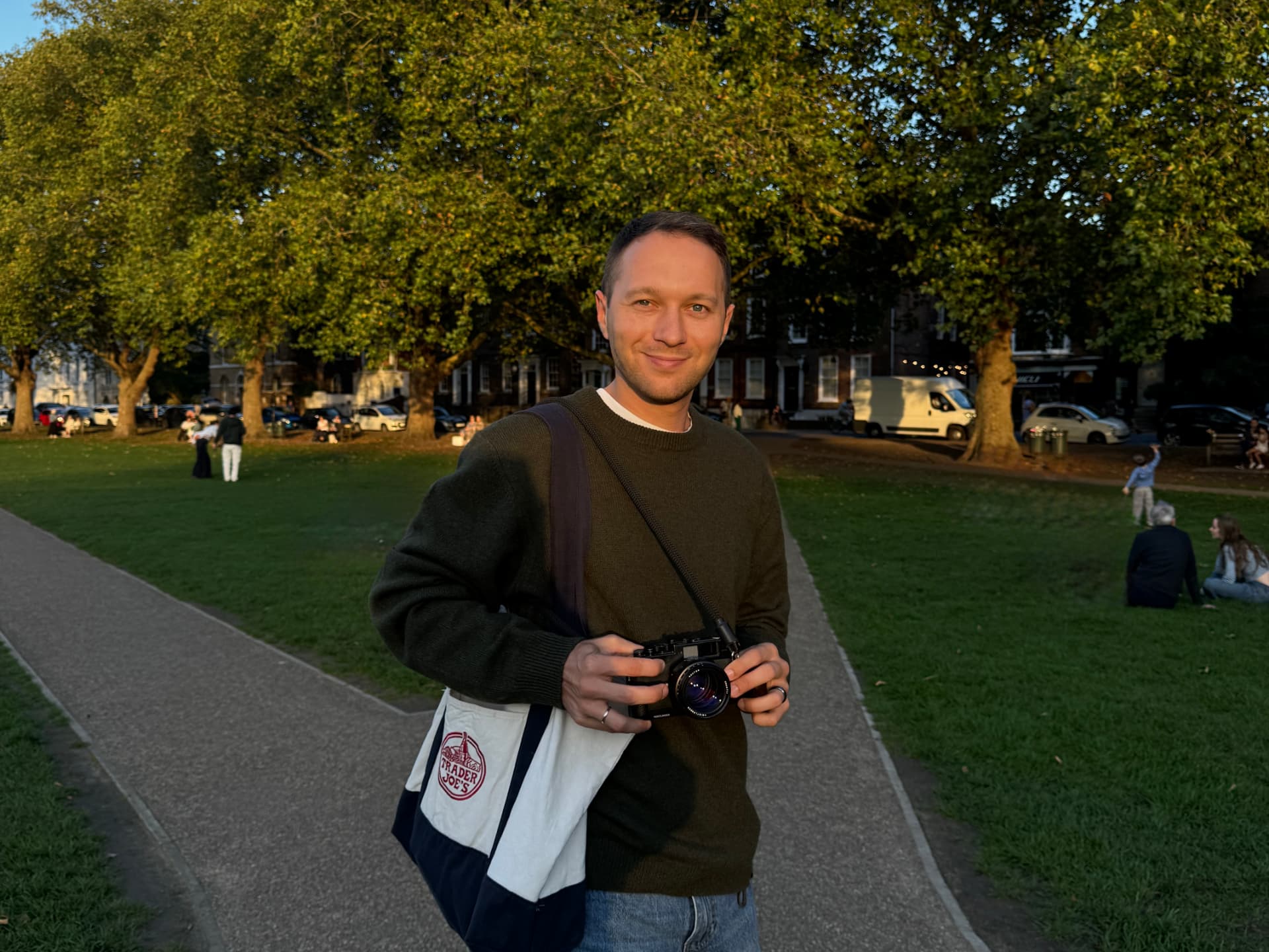 Sergei with a medium format film camera in a London park at sunset