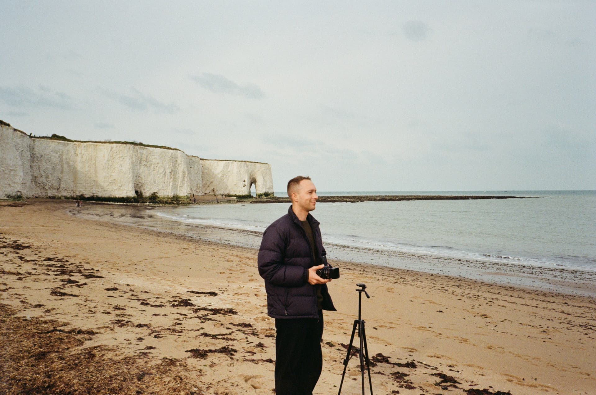 Sergei with a rangefinder camera on a Kent beach